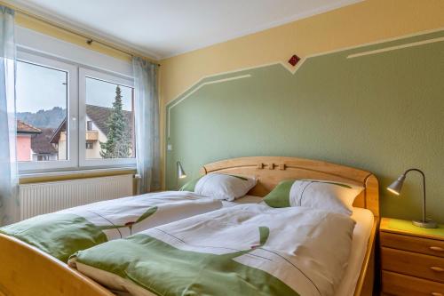 a bedroom with a bed and a large window at Ferienwohnung Smithson in Biberach