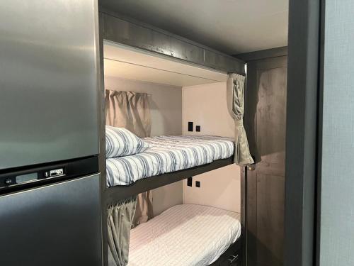 a couple of bunk beds in a room at The Magic Motor Home in Parkland