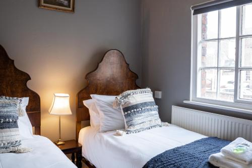 a bedroom with two beds and a window at Historical 2 bed cottage - Chester centre - For 4 in Chester