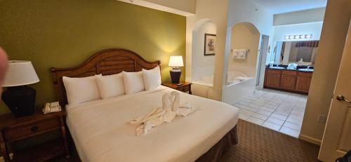 a hotel room with a bed with a towel on it at Best Disney Resort Condo Orlando in Orlando