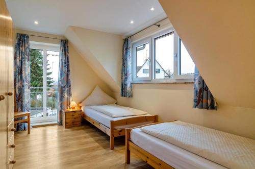 a bedroom with two beds and a window at Haus Eiche in Hödingen