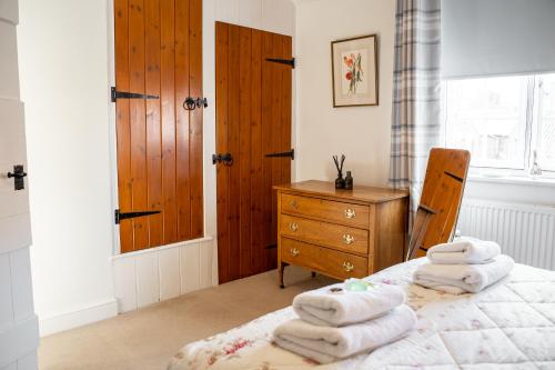 a bedroom with a bed with towels on it at Historical 2 bed cottage - Chester centre - For 4 in Chester