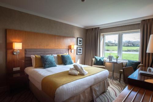 a hotel room with a bed and a window at Lakeside Park Hotel & Spa in Ryde