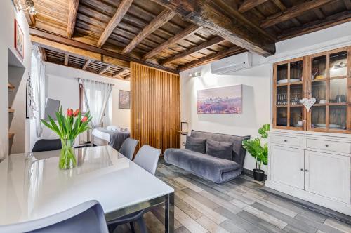 a living room with a table and a couch at Chiavari Apartment in Rome