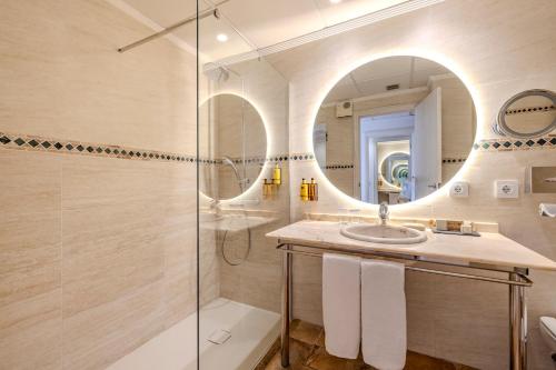 a bathroom with a shower and a sink and a mirror at La Posada del Mar in Denia