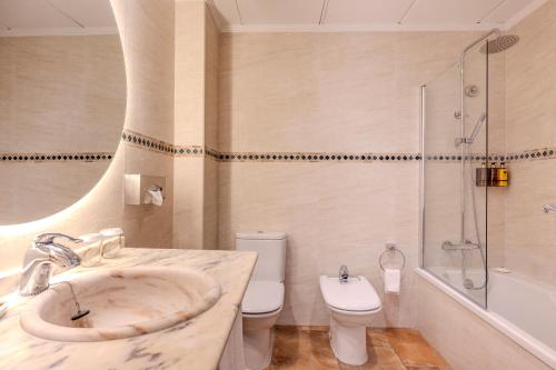 a bathroom with a sink and a toilet and a shower at La Posada del Mar in Denia