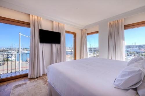 a bedroom with a large bed and a large window at La Posada del Mar in Denia