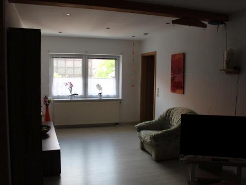 a living room with a couch and a window at Ferienwohnung Sonnenblume in Rhadern