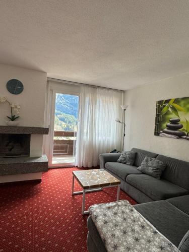 a living room with a couch and a table at Hotel Residence in Grindelwald