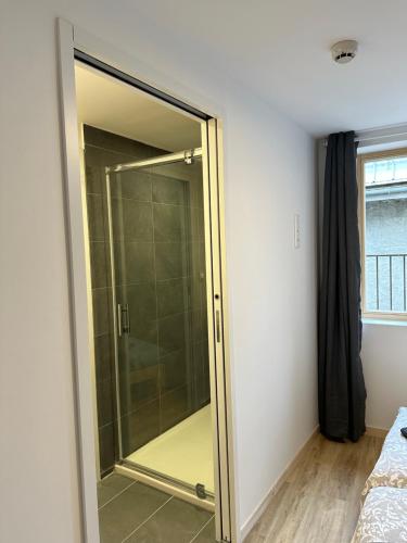 a sliding glass shower door in a bedroom at Résidence le Prorel in Saint-Chaffrey