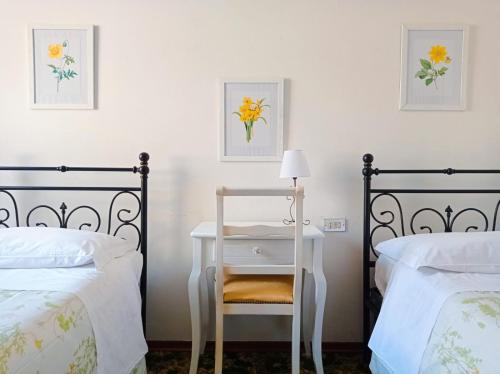 サン・ジミニャーノにあるAffittacamere Chiti Melaniaのベッドルーム1室(ベッド2台、テーブル、椅子付)