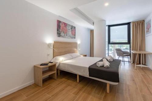 1 dormitorio con cama, escritorio y silla en Duplex 6 pax 2 BTH, excelent area luxor, en Valencia