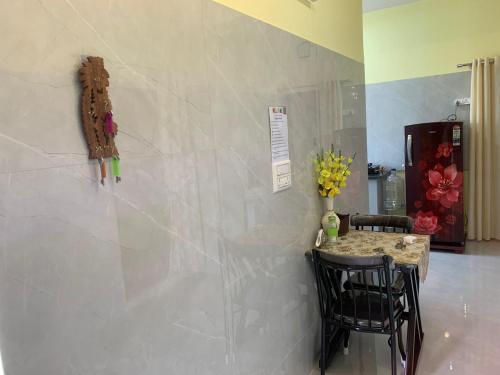a dining room with a table and two chairs at 3BHK Cozy Private Apartment Near BIEC Exhibition Bangalore near IKEA in Bengaluru