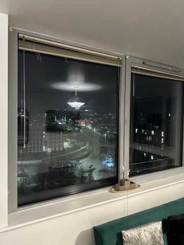 a window with a view of a city at night at City Centre 2 Bed Room Apartment Free Parking in Liverpool