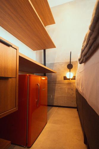 a small kitchen with a red refrigerator in a room at Marilyn Pousada Morro in Morro de São Paulo