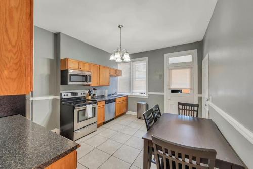 a kitchen with a table and a stove top oven at Ravishing 2-Story Unit in STL 2E in Soulard
