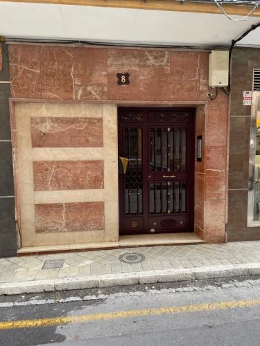 a building with an american flag in front of a door at H&H Suite Plaza de Toros in Granada