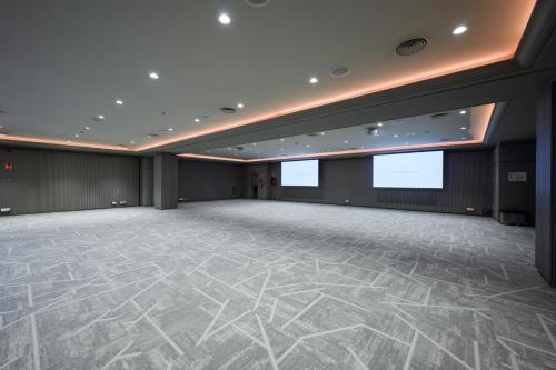 a large room with a large dance floor and two screens at InterContinental Barcelona by IHG in Barcelona