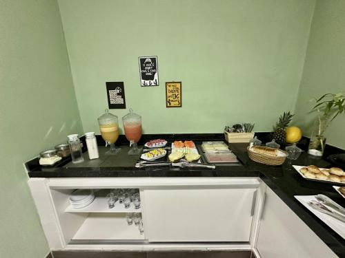 a black counter with some drinks and food on it at Pousada Manaíra in João Pessoa