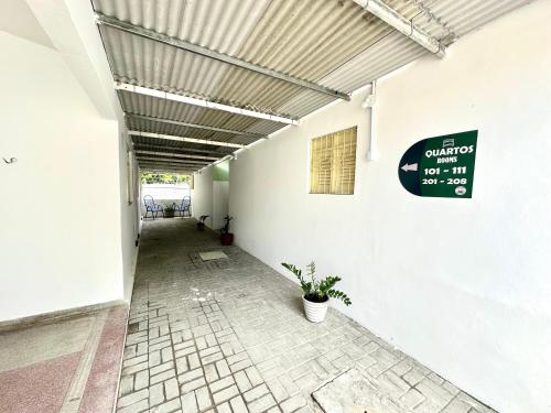 a hallway of a building with a sign on the wall at Pousada Manaíra in João Pessoa