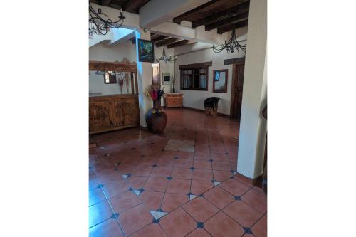 a hallway with a tile floor in a house at OYO Los Alcatraces in Tzintzuntzán