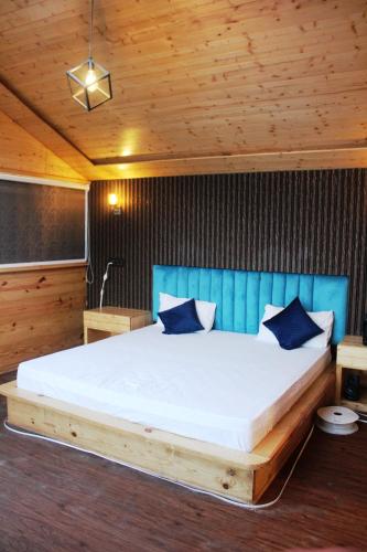 a bedroom with a large bed in a wooden room at THE GRAND RESORT DHANOLTI in Dhanaulti