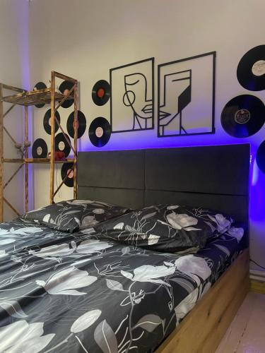 a bedroom with a bed with records on the wall at Old Gyumri in Gyumri