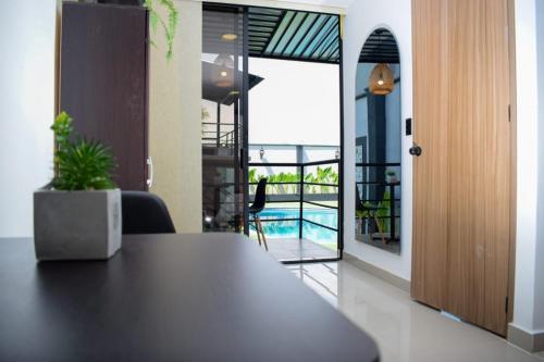 a dining room with a table and a view of a pool at Hotel Boutique Ciudad Jardin in Cali