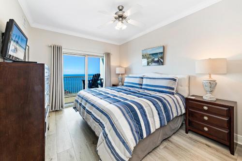 a bedroom with a bed and a tv and a window at Crystal Tower Unit 1508 in Gulf Shores
