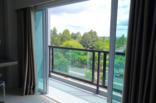 a large window with a view of a street at V Hotel Ubon Ratchathani in Ubon Ratchathani