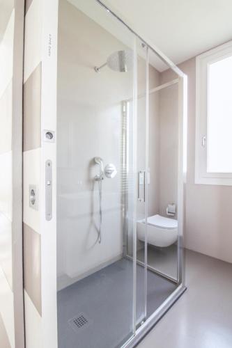 a glass shower in a bathroom with a toilet at La Sosta in San Siro