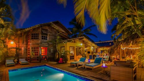 a villa with a swimming pool at night at Casa Calexico in Kralendijk