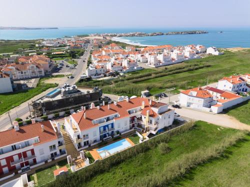 an aerial view of a town with houses and the ocean at Paradise Apartments in Baleal
