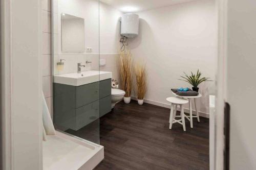 a white bathroom with a sink and a toilet at Stilvolles Apartment in zentraler Lage in Bremen