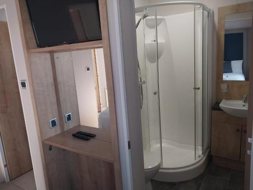 a bathroom with a shower and a sink at Camber Sands Holiday Park in Camber