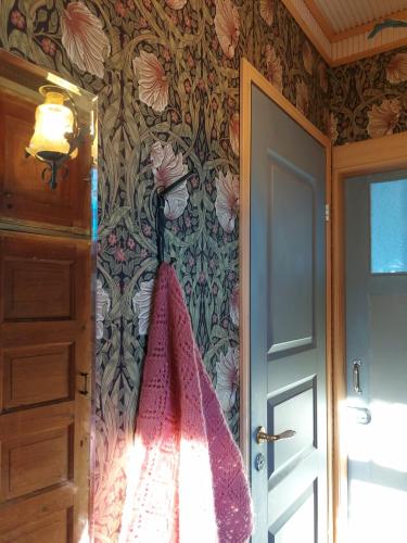 a bathroom with a towel hanging on a wall at Nummenpakan Pysäkki in Turku