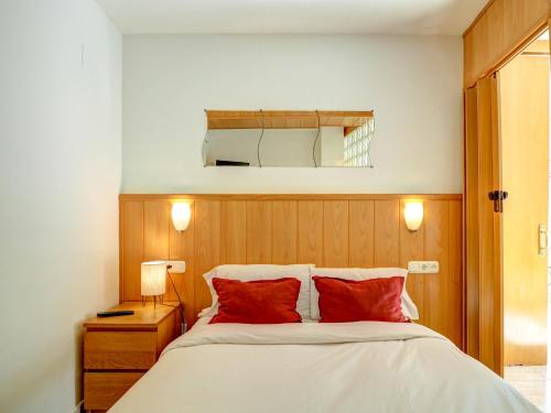 シッチェスにあるBonaire Apartment by Hello Homes Sitgesのベッドルーム1室(大型ベッド1台、赤い枕付)
