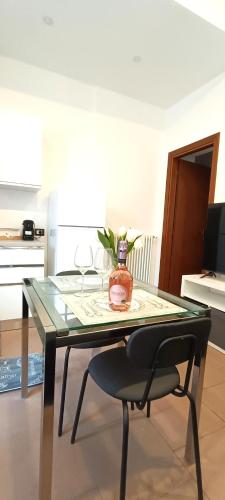 a glass table with a chair and a vase with flowers at Cernobbio Studio in Cernobbio