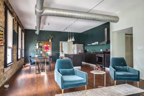 a living room with blue chairs and a table at Luxury Downtown Penthouse with Private Rooftop in Chicago