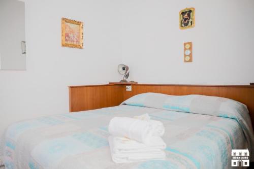 a bedroom with a bed with towels on it at Villa Lena in Bellano