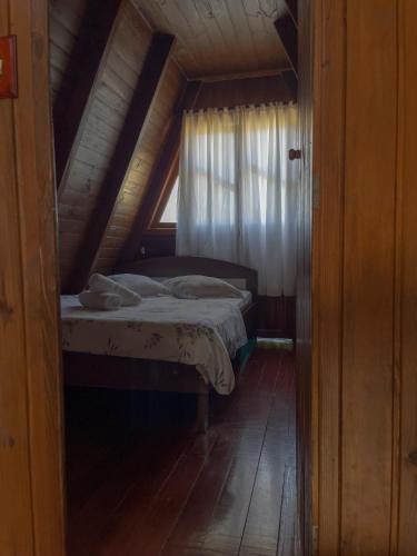 a small bedroom with a bed in a attic at Pousada Scursel in Ibirama