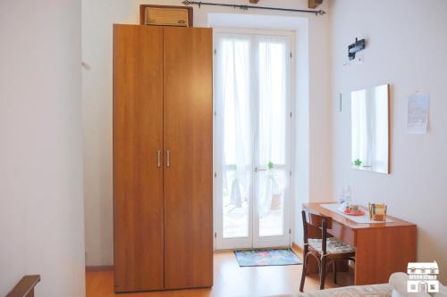 a large wooden cabinet in a living room with a desk at Villa Lena in Bellano