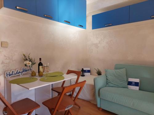 a living room with a table and a couch at House Fiocco di Neve by Holiday World in Limone Piemonte