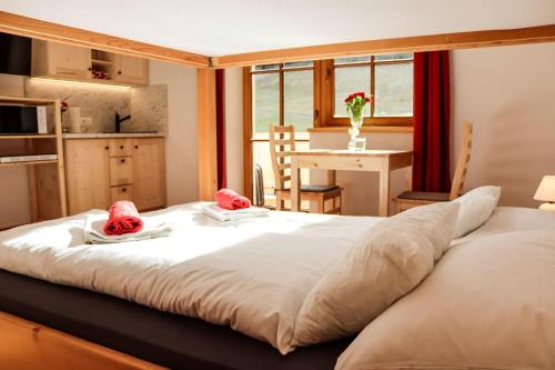 a bedroom with a large bed with two hats on it at Apartment Vordermitterast in Kirchberg in Tirol