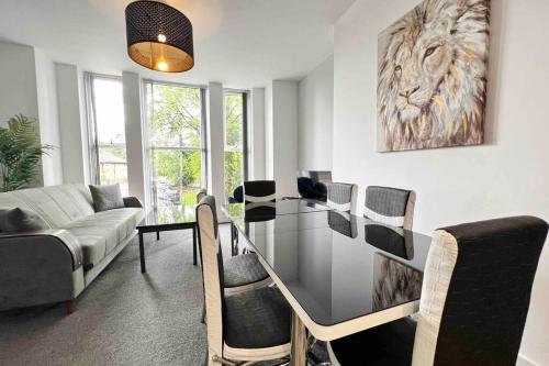 a living room with a glass table and a couch at FREE PARKING - Cosy 2-BR Flat near Salford Royal in Manchester