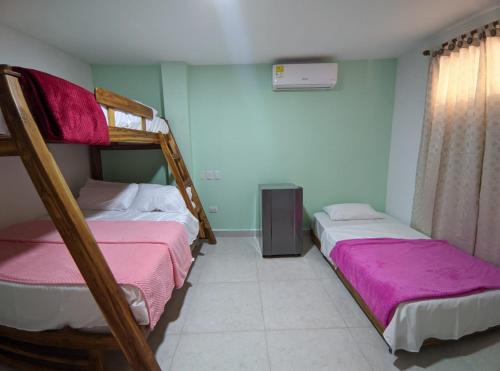 a bedroom with two bunk beds and a window at Dreimar Hotel Boutique in Cartagena de Indias