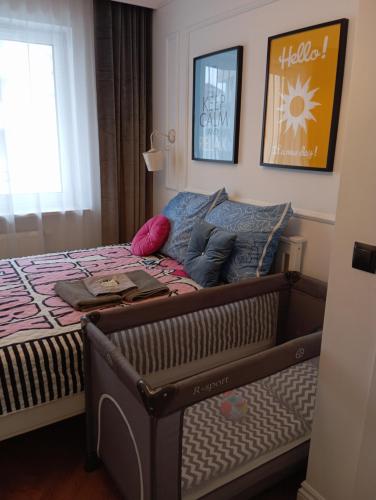 a bedroom with a bed with a laptop on it at Apartament Rainbow in Białystok