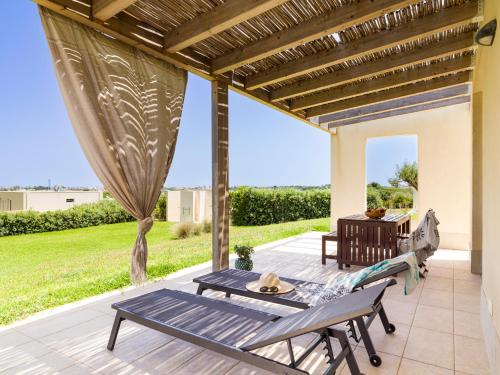 a patio with a table and benches on a porch at Agua Green Resort in San Lorenzo