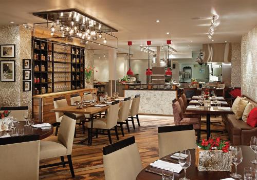 a restaurant with tables and chairs and a bar at Hockley Valley Resort in Orangeville