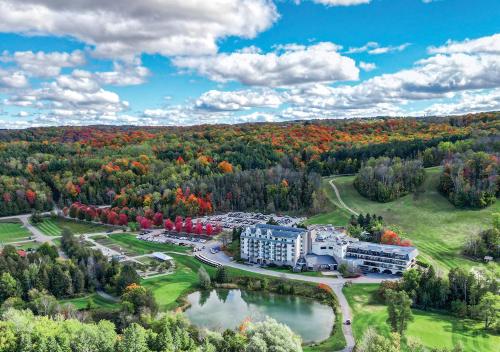 an aerial view of a resort with a lake and trees at Hockley Valley Resort in Orangeville